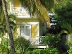 Coco Palm Kreole house with balcony in tropical Garden