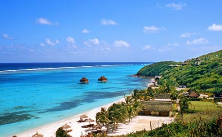 Canouan Resort: beach and spa cottages on poles in the lagoon